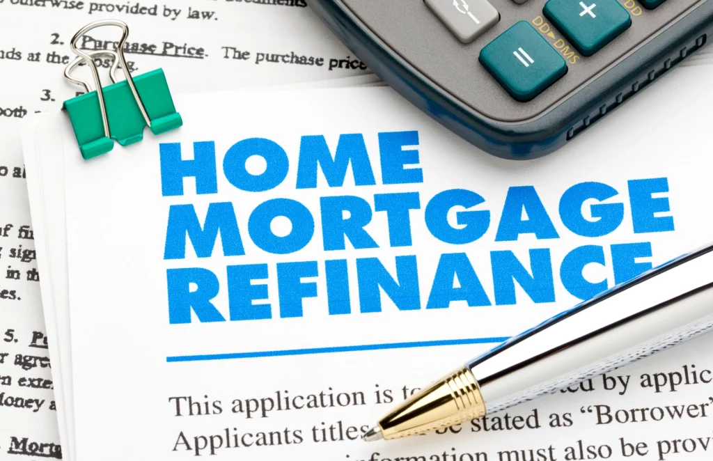 Home mortgage refinance application with pen and calculator, symbolizing the refinancing process